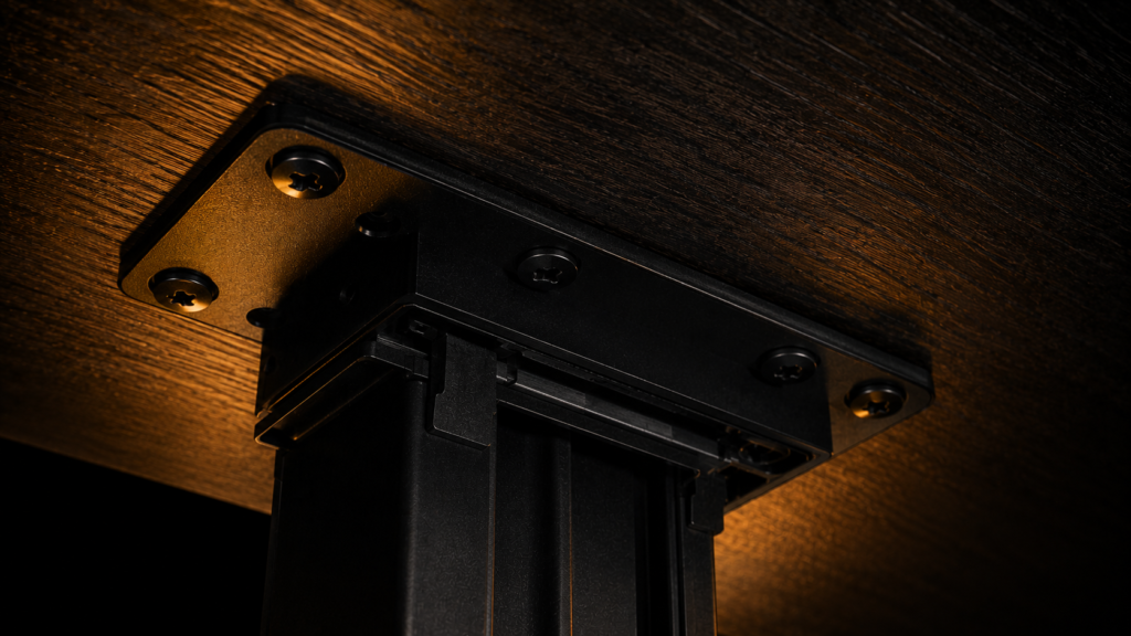 Macro shot of the mounting plate and screw hardware for an under desk PC mount.
